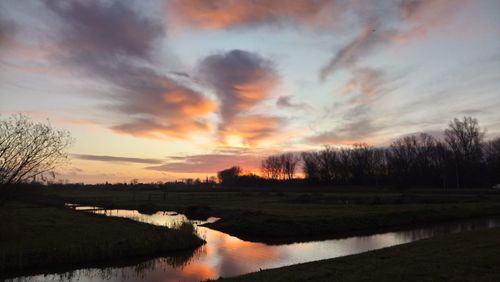 Scenic view of lake against sky during sunset