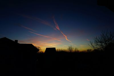 Silhouette of built structure at sunset