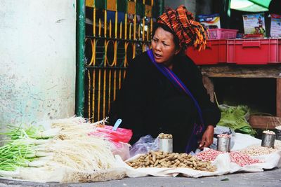 Vendor selling vegetables at market