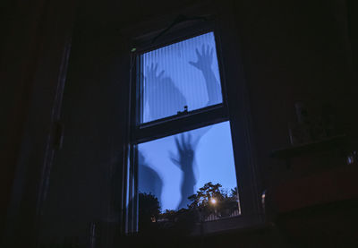 Low angle view of house window at night