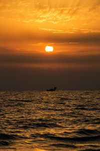 Scenic view of sea against orange sky