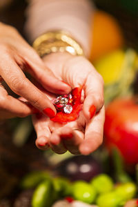 Close-up of woman holding red fruit