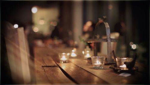 Close-up of candles in glass on table