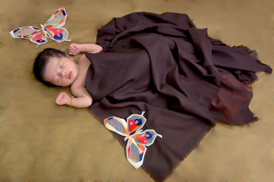 High angle view of cute baby girl sleeping on bed