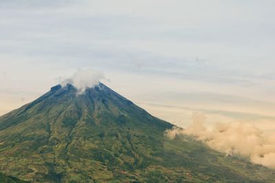 View of volcanic landscape against cloudy sky