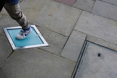 Low section of man standing on floor