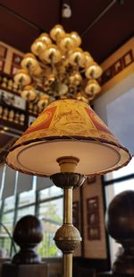 Low angle view of illuminated pendant light on ceiling