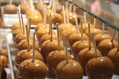 Close-up of sweet chocolate apple candy at local shop 
