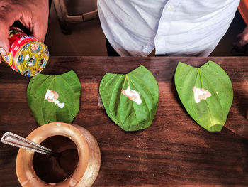 High angle view of man preparing food on table