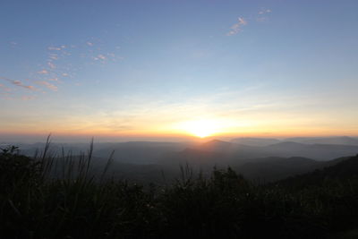 Scenic view of silhouette mountains against sky during sunset