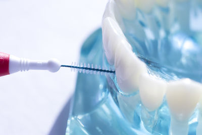 Close-up of brush cleaning dentures