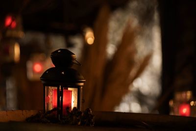 Close-up of illuminated lamp on table