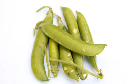 Close-up of green chili pepper against white background