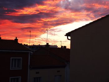 Exterior of houses against sky at sunset