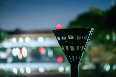 Close-up of illuminated red lights in city at night