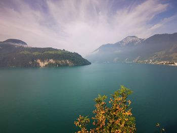 Scenic view of sea and mountains against sky