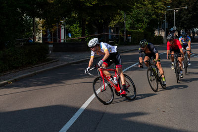 People riding bicycle on road