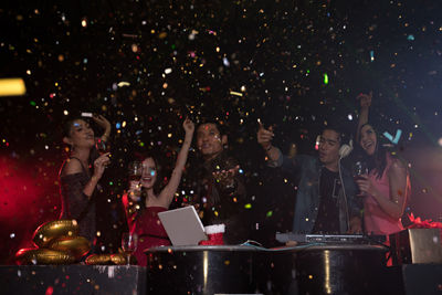 Happy people dancing in nightclub