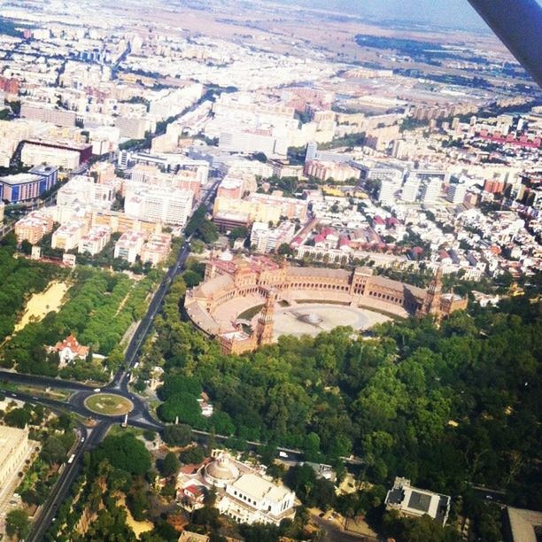 architecture, building exterior, built structure, high angle view, city, cityscape, crowded, tree, residential district, residential building, aerial view, travel destinations, city life, residential structure, travel, town, day, capital cities, roof, elevated view