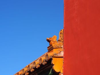 Low angle view of statue against clear blue sky