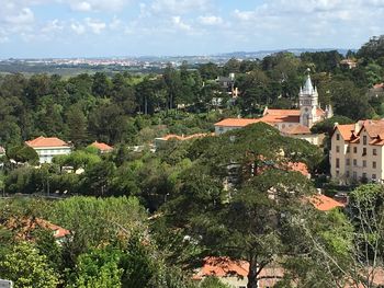 High angle view of townscape and trees against sky