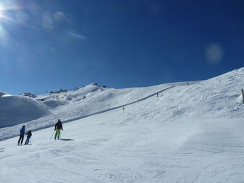 People walking on snow covered mountain