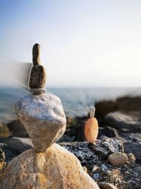 Rocks on beach against sky