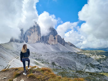 Female traveler looking at mountain peaks