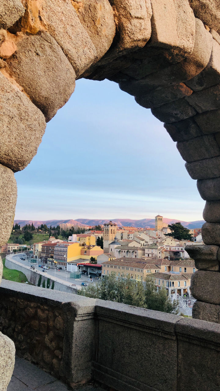 architecture, arch, built structure, ancient history, rock, nature, building exterior, travel destinations, history, the past, travel, sky, building, no people, wall, water, city, day, outdoors, ancient, sea, tourism, clear sky, land, rock formation, temple, cityscape