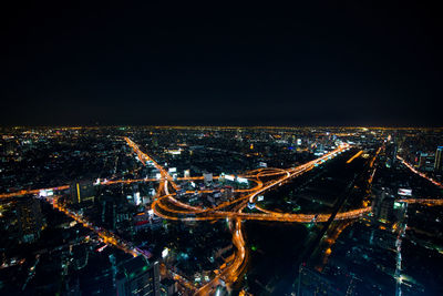 High angle view of illuminated city buildings at night