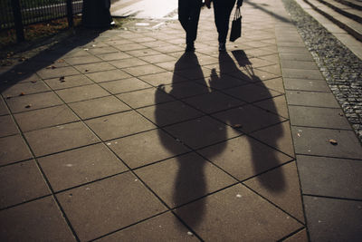 Low section of person walking on sidewalk