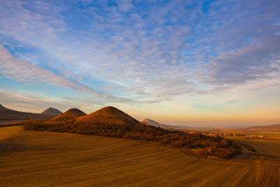 Scenic view of desert against sky during sunset