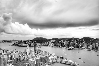 High angle view of city by sea against sky