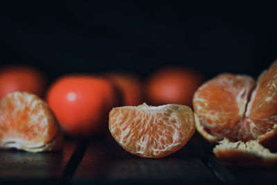 Close-up of fruits on table against black background