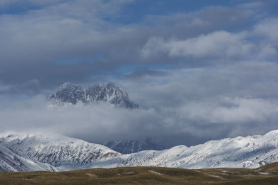 Scenic view of snowcapped mountains against sky