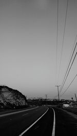 Empty road along trees