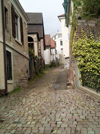 Empty alley amidst buildings in city