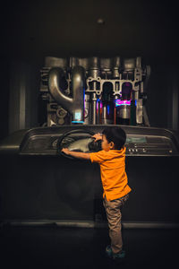 Rear view of boy standing in bus