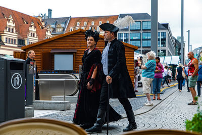 People standing by buildings in city