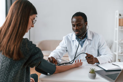 Doctor examining patient at clinic