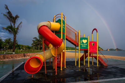 View of playground by swimming pool against sky