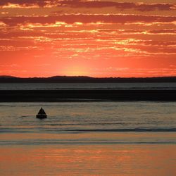 Scenic view of lake at sunset