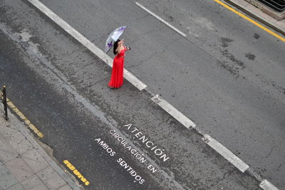 High angle view of person with umbrella on road