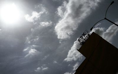 Low angle view of building against cloudy sky