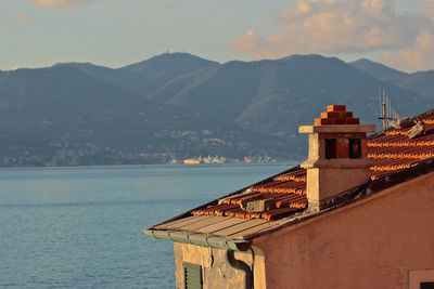 Building by sea against sky