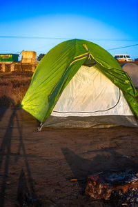 Isolated camping tent with bright blue sky at morning from flat angle