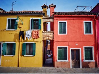 Low angle view of red and yellow buildings on sunny day