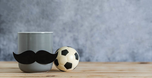 Close-up of ball on table against wall