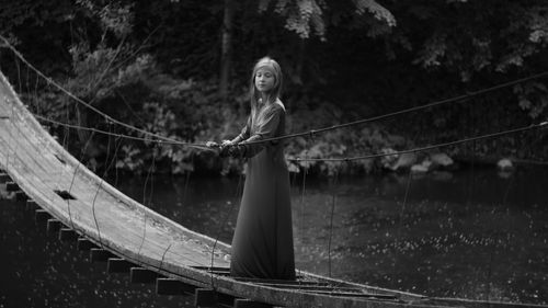 Girl standing on footbridge