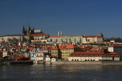 Buildings in city against clear sky